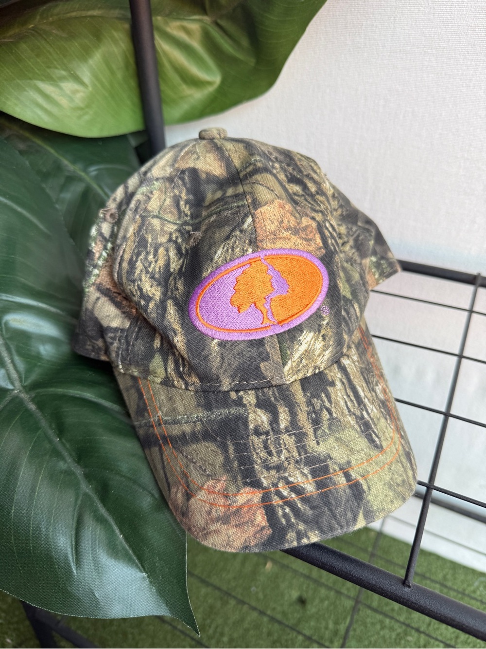 Mossy Oak Camouflage Baseball Cap with Purple and Orange Logo Patch